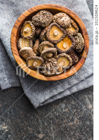 Dried shiitake mushrooms in bowl on kitchen table. Top view. Dried shiitake mushrooms in bowl on kitchen table. Top view. 101509624