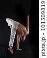circus artist keeps balance on one hand isolated on a black background. Concept of individuality, creativity and self-confidence 101509819