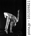 circus artist keeps balance on one hand isolated on a black background. concept of handstand and calisthenic 101509821