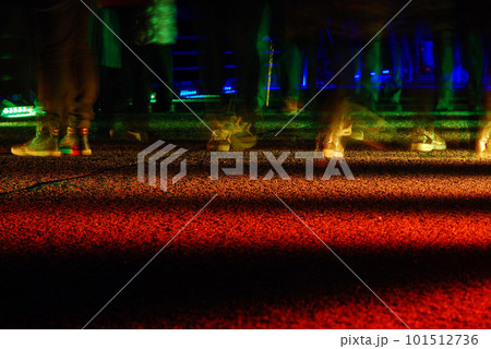 Long exposure shot of feet walking on an illuminated rainbow road in Essen, Germany 101512736
