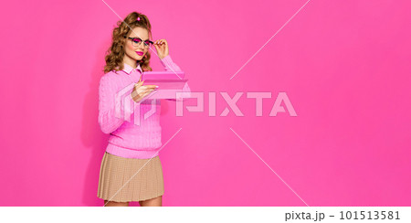 Portraif of young pretty student with blond hair wearing eyeglasses and pink stylish look over studio background. Banner with copy space for ad Portraif of young pretty student with blond hair wearing eyeglasses and pink stylish look over studio background. Banner with copy space for ad 101513581