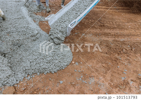 Concrete construction contractors working on pouring wet concrete while paving driveway Concrete construction contractors working on pouring wet concrete while paving driveway 101513793