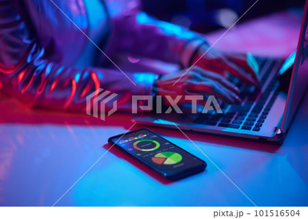 Modern woman using smartphone and exploring graphs 101516504