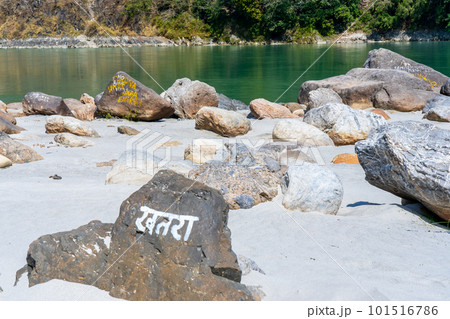 Beautiful River Ganga near Rishikesh with stones and sand beach and Mountains. Pure natural clean river water.  101516786