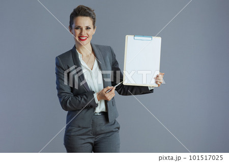 happy elegant business owner woman isolated on grey 101517025