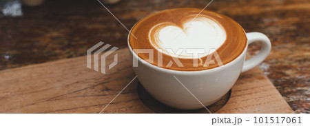 Hot coffee in white cup on wooden tray with Copy space. Banner cover design. Hot coffee in white cup on wooden tray with Copy space. Banner cover design. 101517061