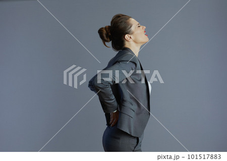 tired stylish woman employee having back pain isolated on grey 101517883