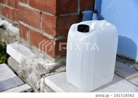 White plastic large canister. An empty plastic canister. 101518562