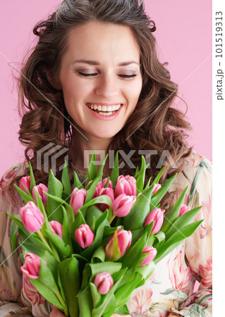 happy elegant woman in floral dress on pink 101519313