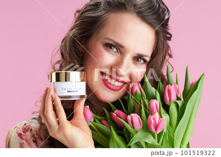 Portrait of smiling modern woman in floral dress on pink Portrait of smiling modern woman in floral dress on pink 101519322