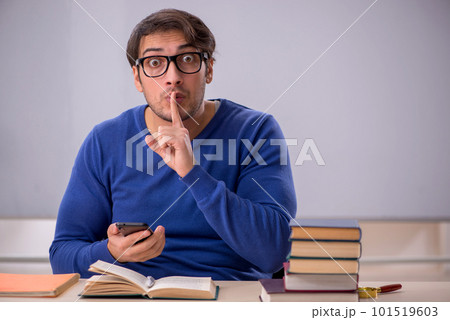 Young male student preparing for exams in the classroom Young male student preparing for exams in the classroom 101519603