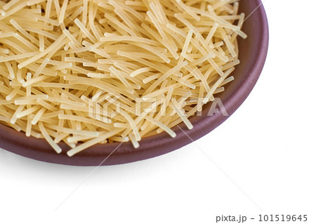 Pasta noodles in a clay ceramic bowl close-up isolated on a white background Pasta noodles in a clay ceramic bowl close-up isolated on a white background 101519645