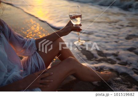 Stylish woman in elegant white dress posing near the sea. People, freedom, lifestyle, travel. 101519682