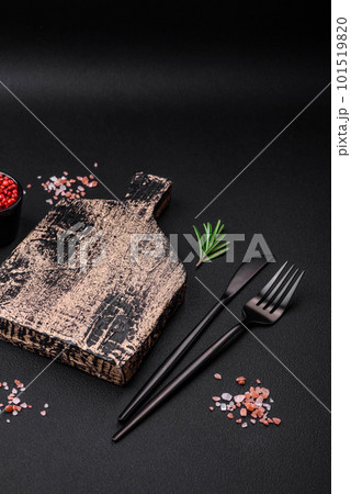 Empty wooden cutting board on dark concrete background 101519820