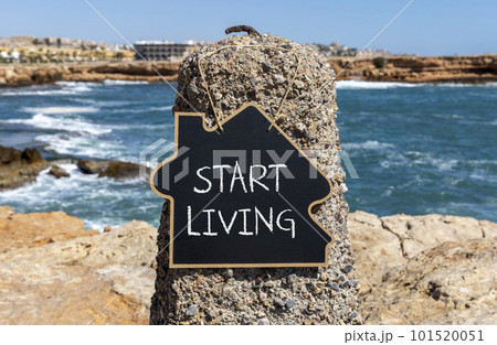 Start living symbol. Concept words Start living on beautiful black chalk blackboard. Beautiful stone sea beach background. Business and Start living concept. Copy space. Start living symbol. Concept words Start living on beautiful black chalk blackboard. Beautiful stone sea beach background. Business and Start living concept. Copy space. 101520051