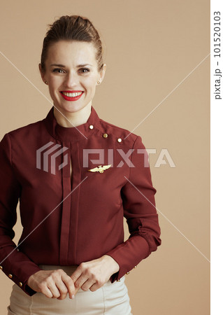happy stylish stewardess woman on beige background 101520103