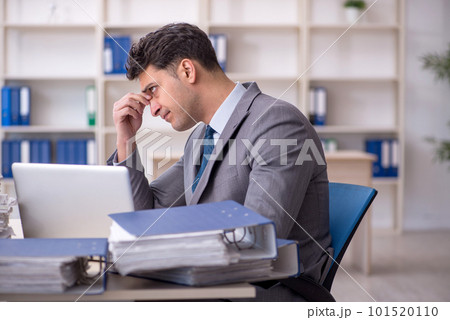 Young male employee working in the office 101520110