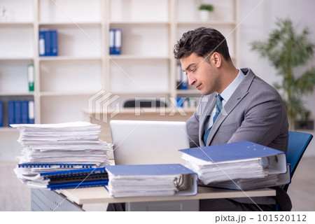 Young male employee working in the office 101520112