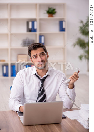 Young male employee working in the office 101520737