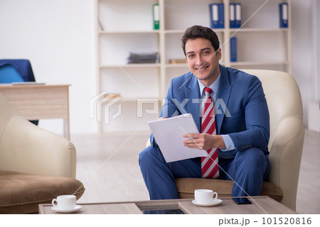 Young male employee sitting in the office Young male employee sitting in the office 101520816