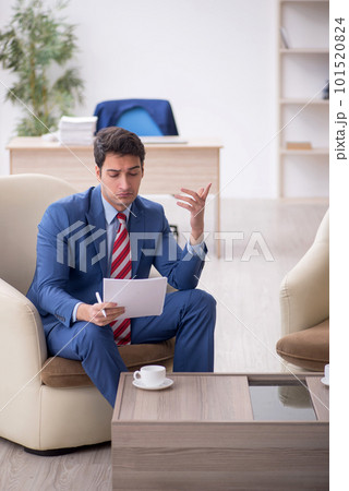 Young male employee sitting in the office 101520824