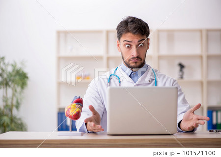 Young male doctor in telemedicine concept 101521100
