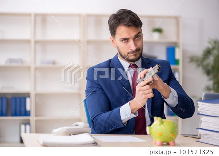 Young male employee in planning retirement concept Young male employee in planning retirement concept 101521325