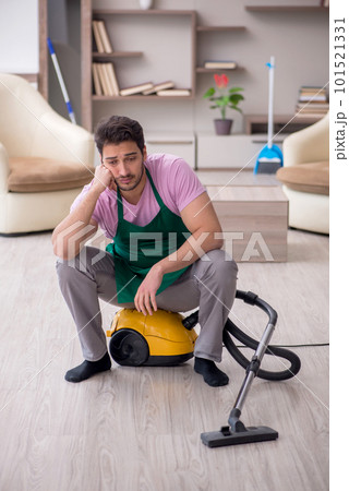 Young male contractor cleaning the house 101521331