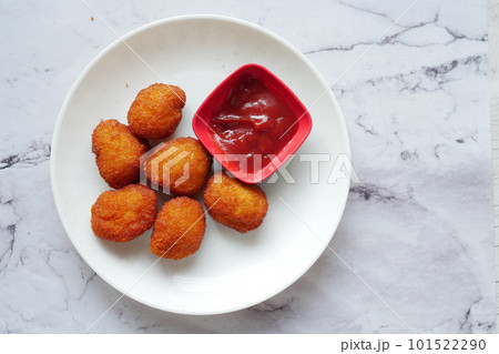 close up of chicken nugget and sauce on table close up of chicken nugget and sauce on table 101522290