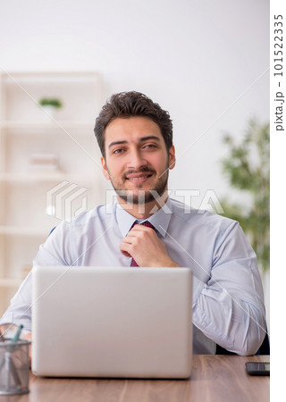Young male employee working in the office Young male employee working in the office 101522335