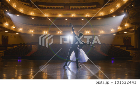 Classical ballet dancers practice on theatre stage Classical ballet dancers practice on theatre stage 101522443
