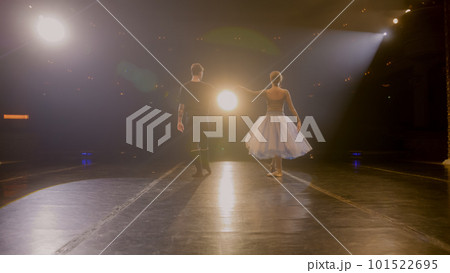 Ballet dancers come out from behind curtains and dance 101522695