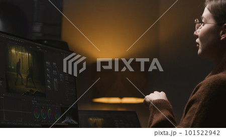 The colorist edits video, makes movie color correction 101522942