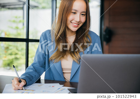 Asian woman working with laptop computer she analyst financial advisor preparing statistic report studying documents, Businesswoman audit financial charts and graphs 101522943