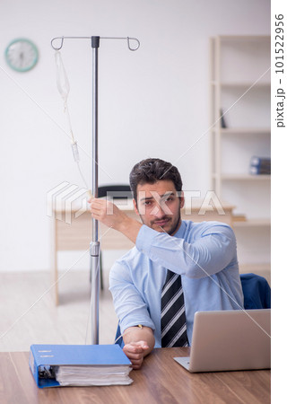 Young male employee suffering at workplace Young male employee suffering at workplace 101522956
