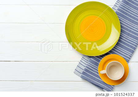 Top view of color ceramic plate on wooden background Top view of color ceramic plate on wooden background 101524337