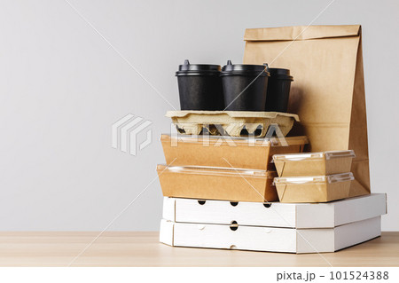 Many various take-out food containers, pizza box, coffee cups and paper bags on light grey background Many various take-out food containers, pizza box, coffee cups and paper bags on light grey background 101524388