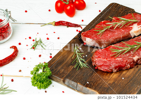 Barbecue veal steaks with rosemary on wooden board Barbecue veal steaks with rosemary on wooden board 101524434
