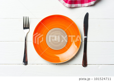 Top view of color ceramic plate on wooden background 101524711