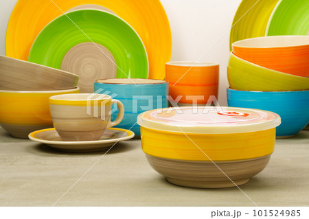 Set of colored ceramic dishware front view 101524985