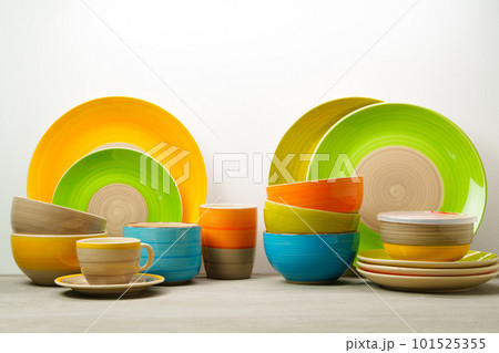 Set of colored ceramic dishware front view 101525355