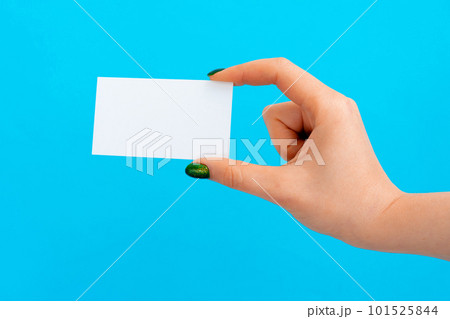 Woman hand holding blank card on blue background Woman hand holding blank card on blue background 101525844