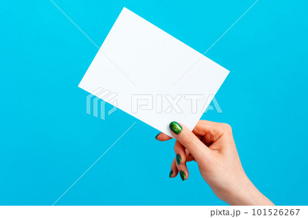 Woman hand holding blank card on blue background 101526267