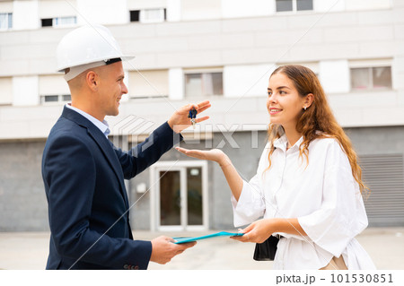 Real estate manager giving keys to woman Real estate manager giving keys to woman 101530851