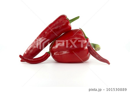 Fresh chili peppers and red bell peppers over white 101530889