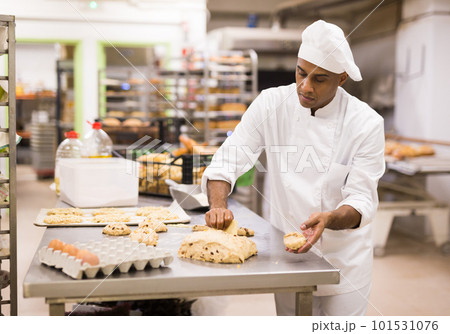 Baker at work - making sweet buns with dough Baker at work - making sweet buns with dough 101531076