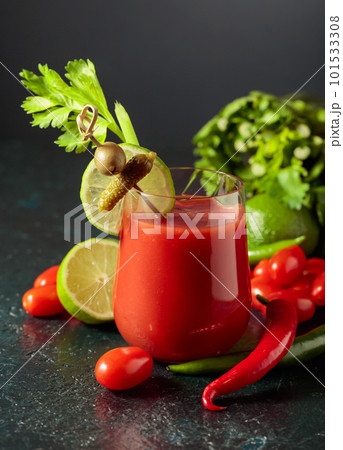 Bloody Mary cocktail garnished with gherkin, olive, lime, and celery. Bloody Mary cocktail garnished with gherkin, olive, lime, and celery. 101533308
