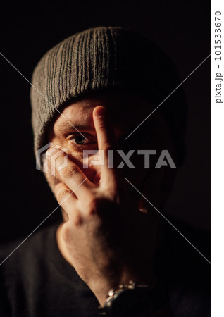 Serious dramatic man looking away while standing against black studio background 101533670