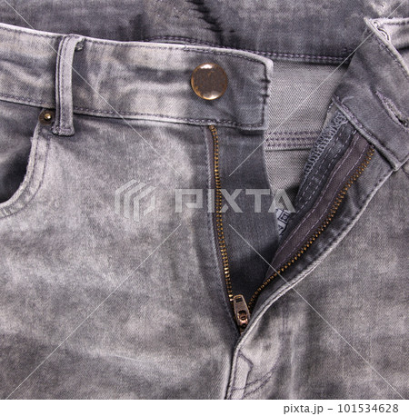 Worn grey jeans isolated, zipper open Worn grey jeans isolated, zipper open 101534628