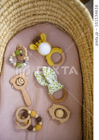 in a basket natural wooden knitted toys for a newborn. View from above 101534638
